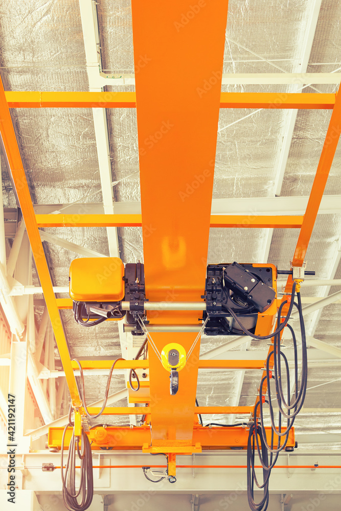 Overhead crane inside factory or warehouse. That industrial machinery or lifting equipment