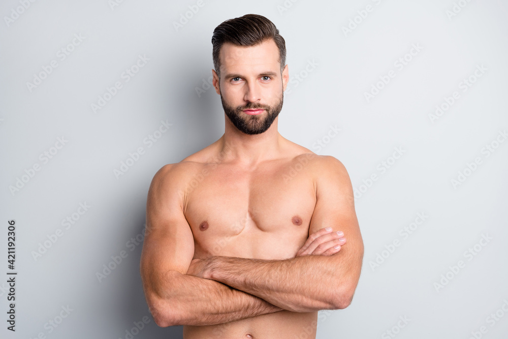 Portrait of attractive athletic well-groomed fit guy bodybuilder folded arms isolated over light grey color background Portrait of attractive athletic well-groomed fit guy bodybuilder folded arms isolated over light grey color background
