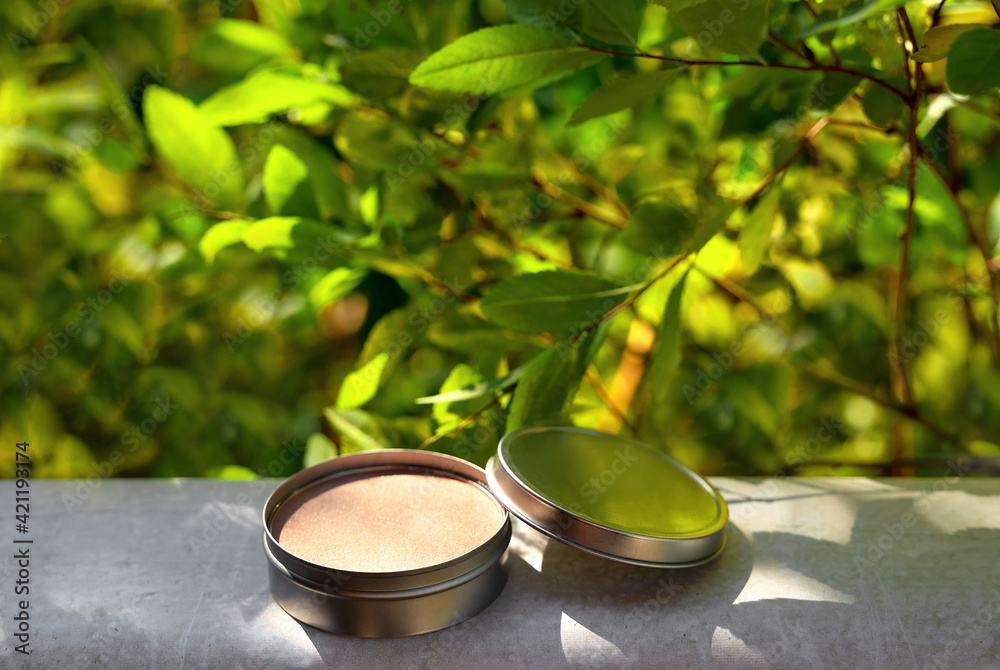 Cosmetic display on green leaves and natural stone backdrop. Natural cosmetics and beauty concept. Cosmetic banner design. Cosmetic display on green leaves and natural stone backdrop. Natural cosmetics and beauty concept. Cosmetic banner design.