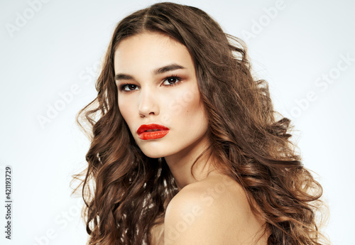 Side view of lady with curly hair red lips