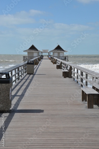 Vertical photo of an empty pier in Naples, Florida, USA