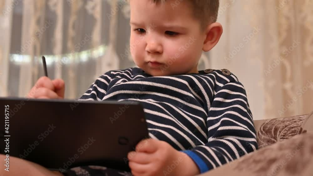 Child draws on a graphics tablet. High quality video