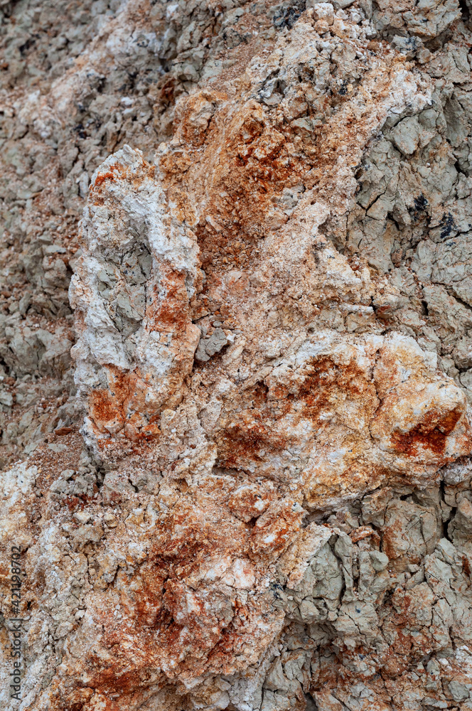 Naklejka premium White and brown clay background, uneven soil surface blurred rainy water, natural material outdoors, close-up photo.