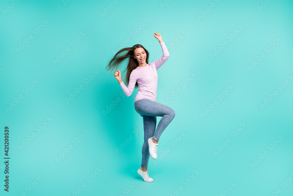 Full length body size view of lovely cheerful girl jumping dancing rejoicing isolated over turquoise bright color background Full length body size view of lovely cheerful girl jumping dancing rejoicing isolated over turquoise bright color background