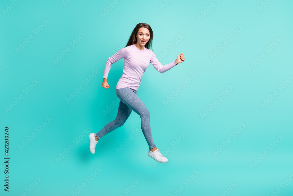 Full length body size view of attractive cheerful girl jumping running fast speed isolated over turquoise bright color background