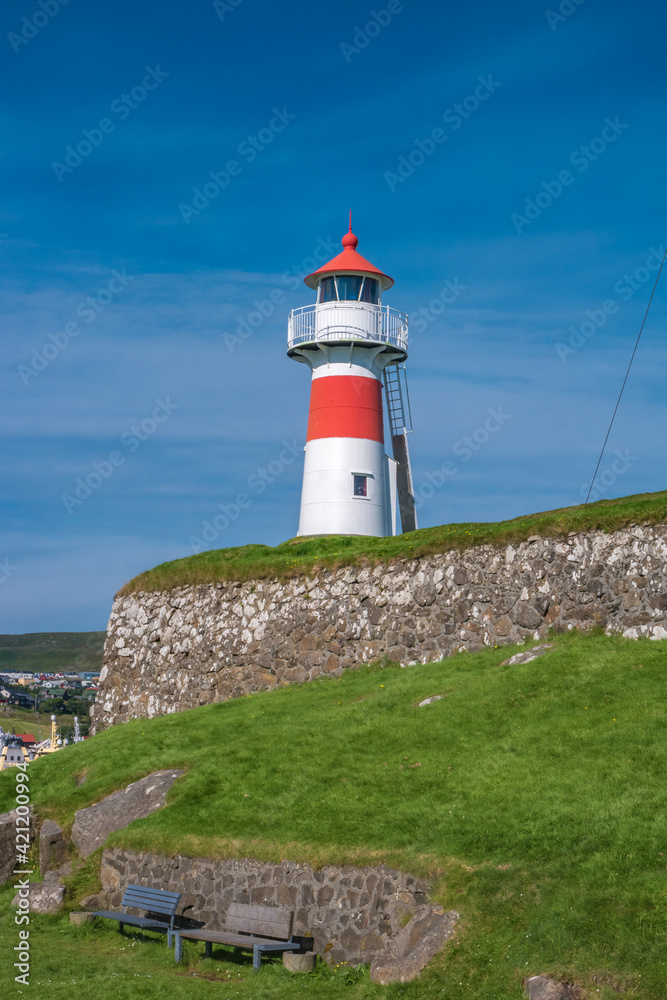 Old lighthouse and fortress in the harbor of Torshavn, the capital of Faroe islands archipelago in Atlantic ocean, summer.