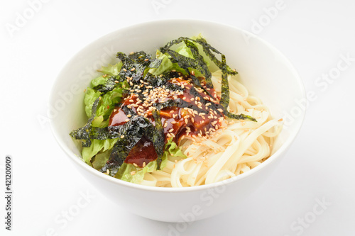Seasoning cut noodles on a white background