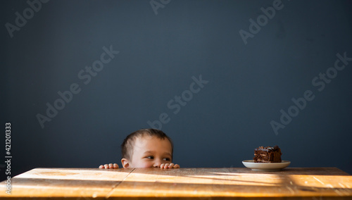 Little boy wants to eat cake, selective focus