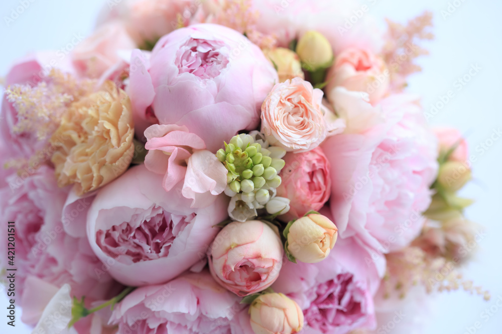 Floral arrangement of fresh pink peonies, astilba, rose and carnation. The bride's bouquet. Florist work