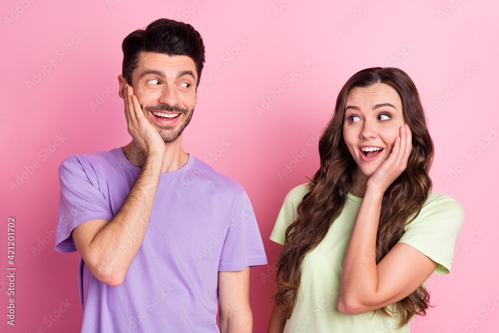 Portrait of nice attractive amazed cheerful couple good news reaction isolated over pink pastel color background Portrait of nice attractive amazed cheerful couple good news reaction isolated over pink pastel color background