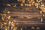 Slices of dried apples on a wooden background.
