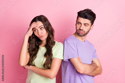 Profile side view portrait of attractive offended serious couple standing back to back fight isolated over pink pastel color background