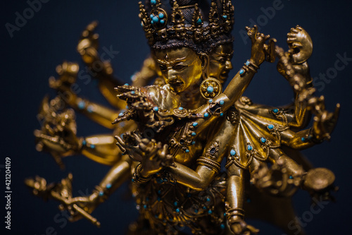 Yab-Yum, golden statue of deities and buddhas in amorous intercourse with his wife