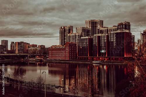 Reflection in the water of a massive building, Yekaterinburg, Russia, shot on a cloudy day.