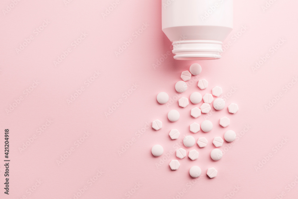 Medicine pills with bottle on pink background Medicine pills with bottle on pink background