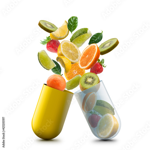 vitamin c pill open with citrus fruits jumping out