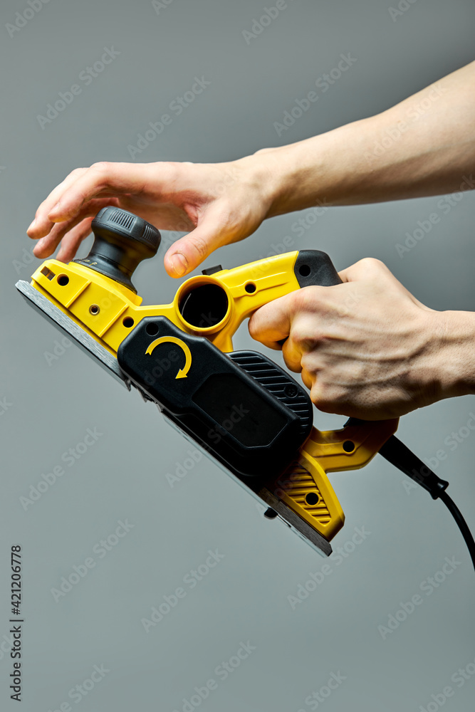 Carpenter hands turn on electric planer jointer Stock Photo Adobe Stock