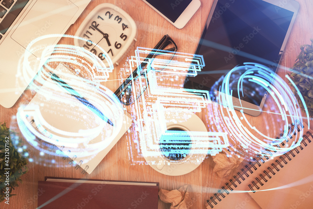 Double exposure of SEO hologram drawing over desktop. Top view. Search optimization concept. Double exposure of SEO hologram drawing over desktop. Top view. Search optimization concept.