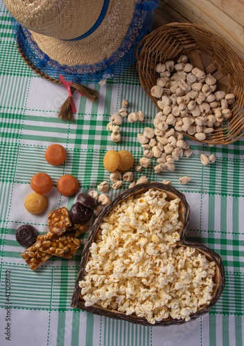 Festa junina in Brazil, typical festa junina table in brazil with popcorn and typical sweets and props, black background, top view.