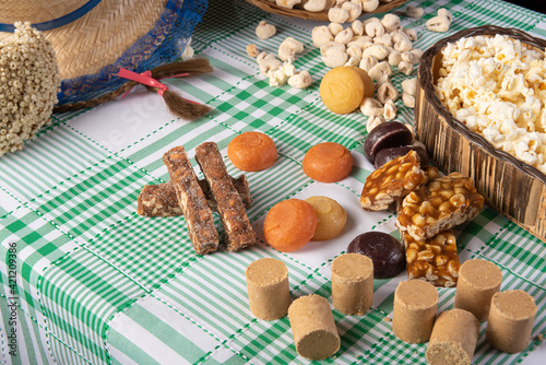 Festa junina in Brazil, typical festa junina table in brazil with popcorn and typical sweets and props, black background, selective focus.