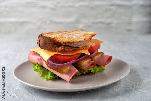 Sandwich with ham, tomatoes, lettuce and yellow cheese