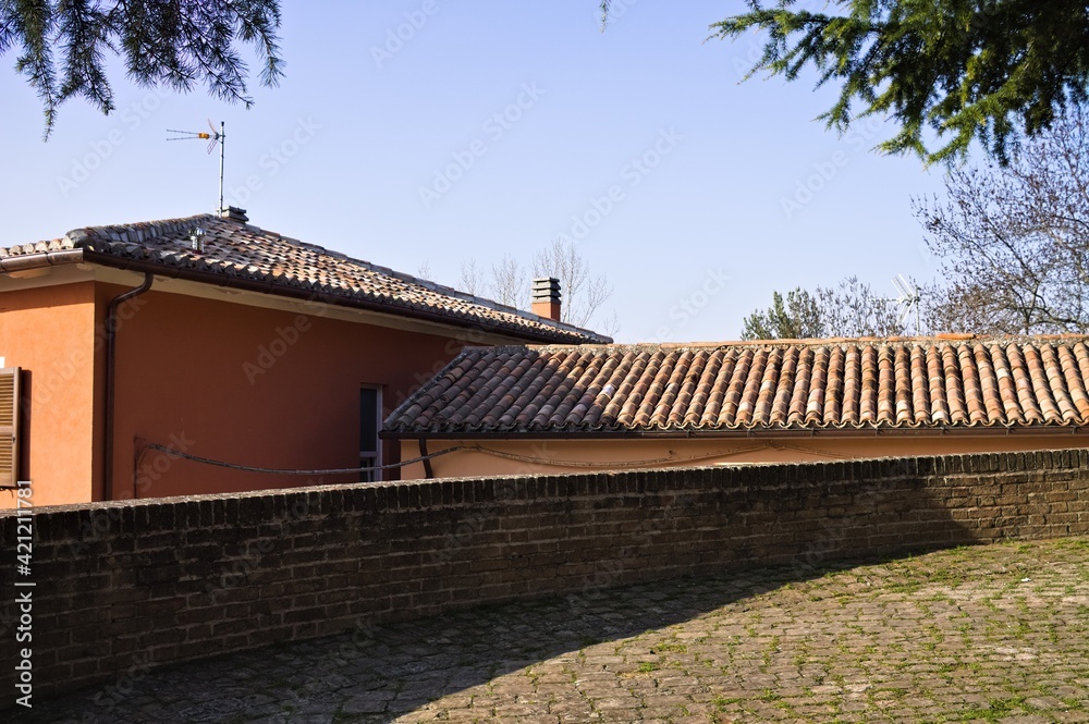 A walkway in a medieval village with roof tiles in background (Marche, Italy, Europe)