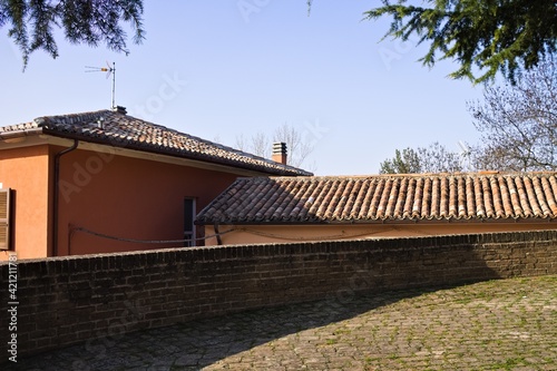 A walkway in a medieval village with roof tiles in background (Marche, Italy, Europe) © Tommaso