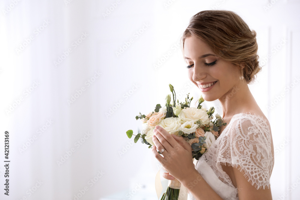 Young bride with beautiful wedding bouquet on light background. Space for text Young bride with beautiful wedding bouquet on light background. Space for text