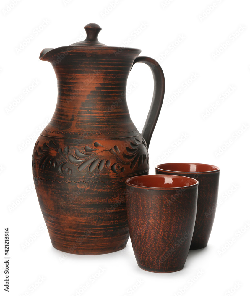 Brown clay jug and cups on white background