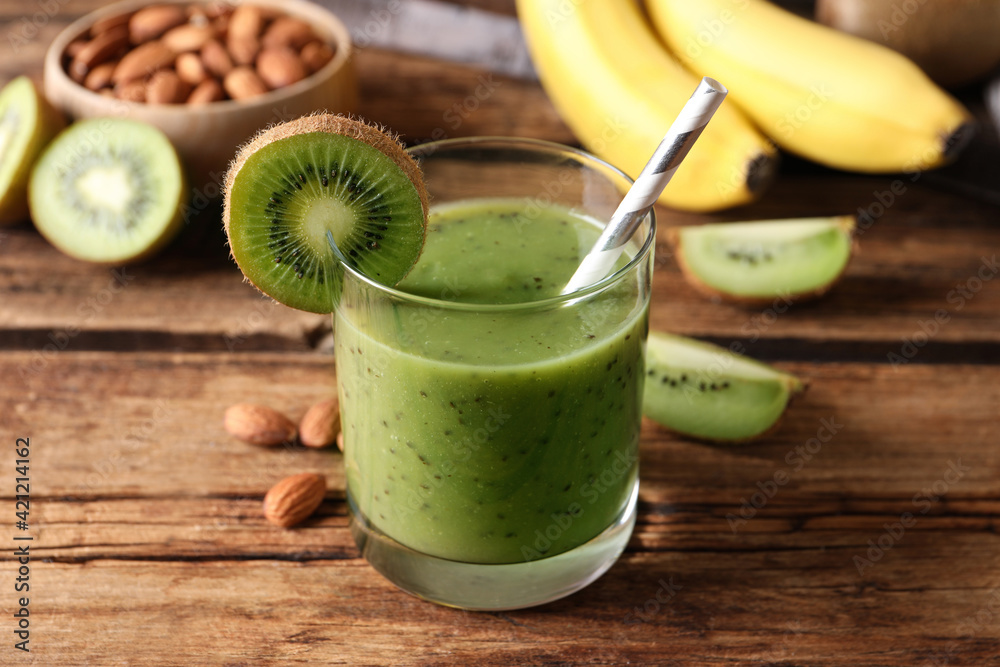 Delicious kiwi smoothie and ingredients on wooden table Delicious kiwi smoothie and ingredients on wooden table