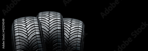 three summer modern tires on a black background. place for advertising and text copyspace photo