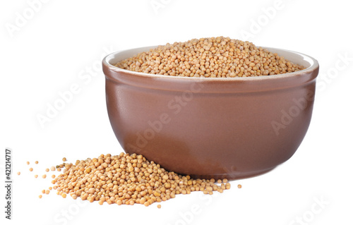 Mustard seeds with bowl isolated on white