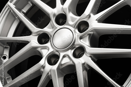 beautiful sporty alloy wheels forged in silver color, center part and cover close-up