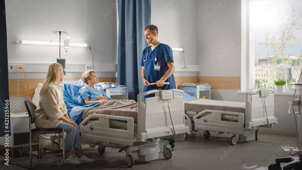 Hospital Ward: Handsome Young Boy Resting in Bed with Caring Mother Visits to Support Him, Friendly Doctor Talks. Surgeon, Nurse Gives Advice to Happy Patient Recovering after Sickness Hospital Ward: Handsome Young Boy Resting in Bed with Caring Mother Visits to Support Him, Friendly Doctor Talks. Surgeon, Nurse Gives Advice to Happy Patient Recovering after Sickness