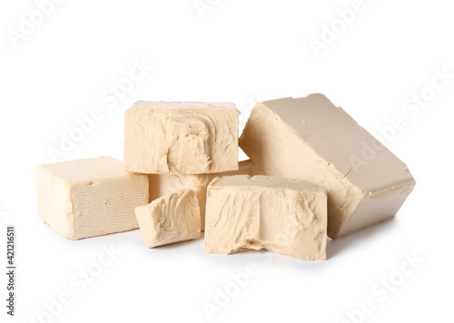 Pieces of compressed yeast on white background