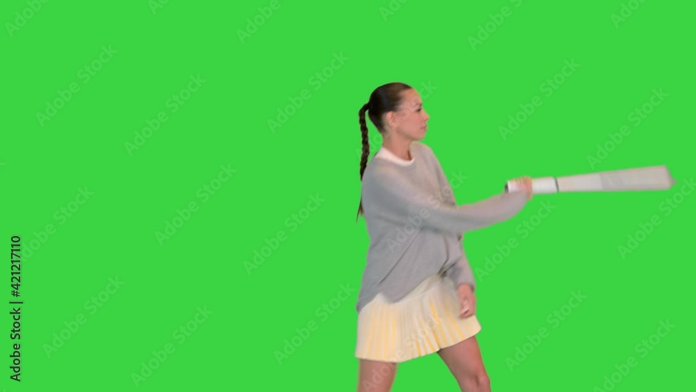 Girl with tennis racket imitating the game on a Green Screen, Chroma Key. Girl with tennis racket imitating the game on a Green Screen, Chroma Key.