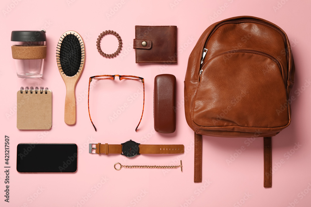 Stylish urban backpack and different items on pink background, flat lay Stylish urban backpack and different items on pink background, flat lay