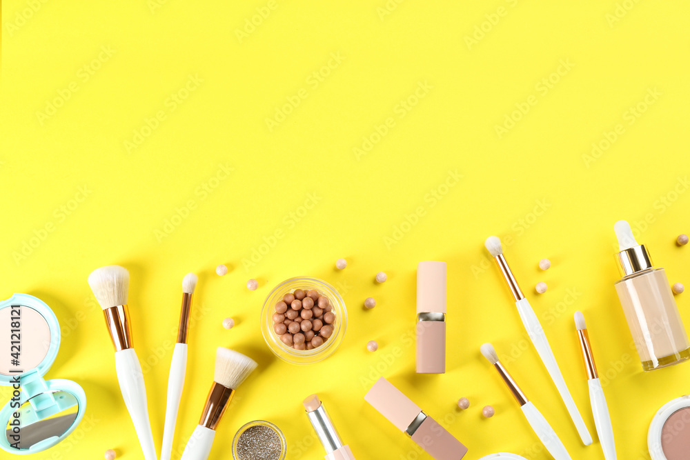 Flat lay composition with makeup brushes on yellow background, space for text - obrazy, fototapety, plakaty 