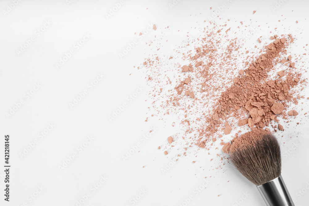 Makeup brush and scattered face powder on light background, flat lay. Space for text Makeup brush and scattered face powder on light background, flat lay. Space for text