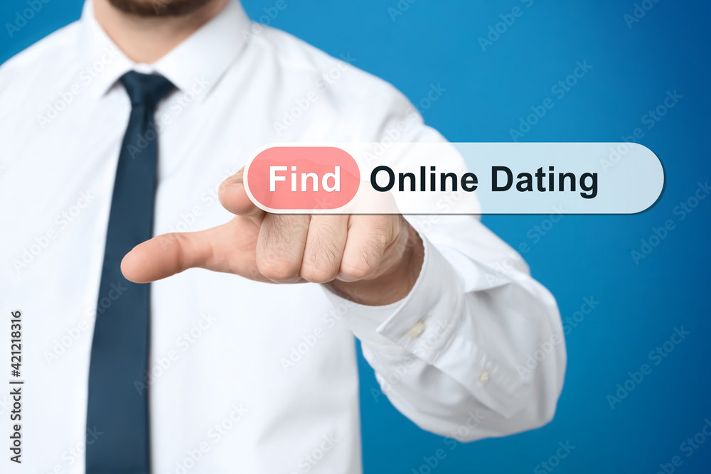 Man pointing at search bar with request Online Dating on blue background, closeup Man pointing at search bar with request Online Dating on blue background, closeup
