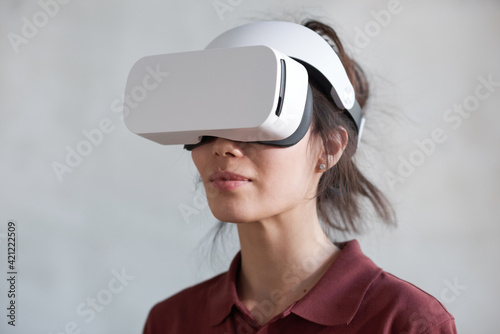 Woman in virtual reality headset or 3D glasses