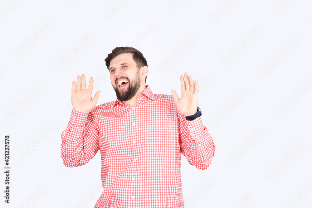 Fototapeta premium A bearded man in a pink checked shirt laughs. Young unshaven guy funny