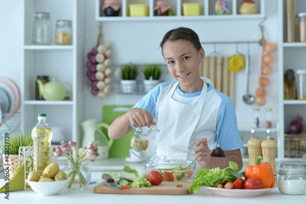 Cute boy preparing  cooking  at home