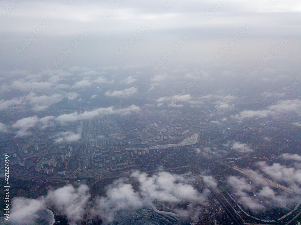 Fototapeta premium Aerial high view. Flight over the clouds of Kiev.