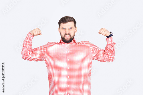 A man in a pink checkered shirt shows off his biceps. A guy with a beard does intimidating poses