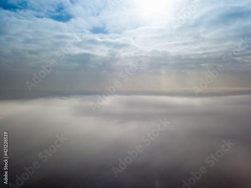 Aerial high view. Flying over the clouds.