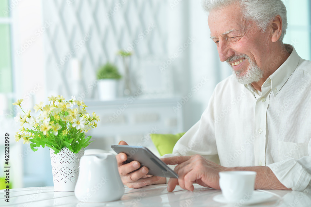 Portrait of  senior man using tablet