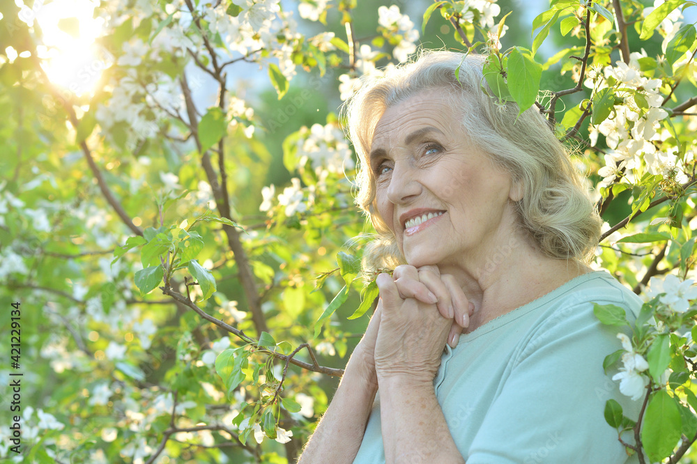 Happy senior beautiful woman in spring park Happy senior beautiful woman in spring park