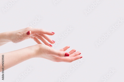 Women's hands. Spa manicure on a gray background.