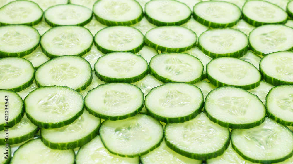Fresh green slices of cucumber as background. Fresh green slices of cucumber as background.